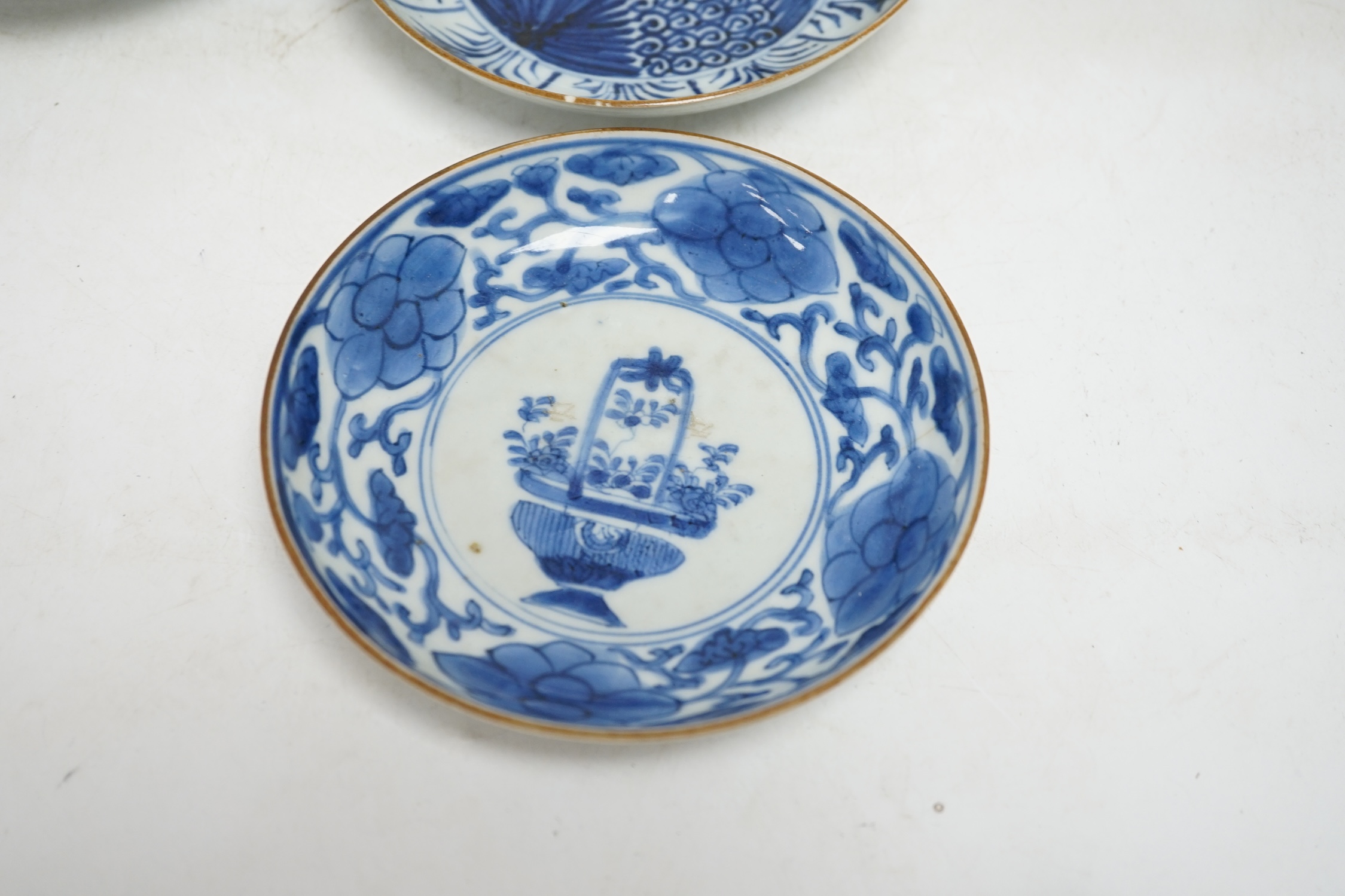 Five variously patterned Chinese blue and white saucer dishes, Kangxi period, largest 16cm diameter. Condition - chips and cracks to three items